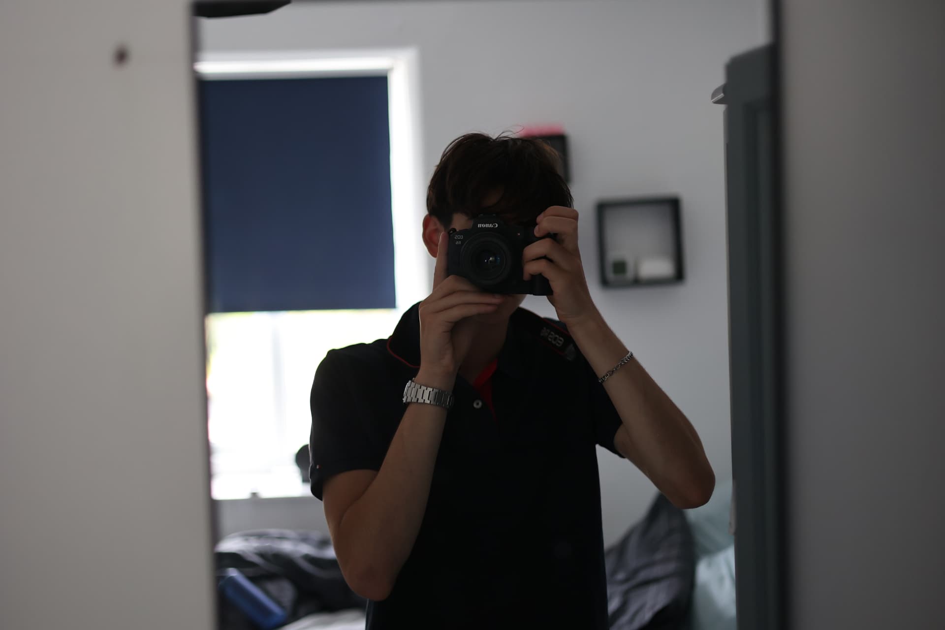 Santiago, commercial photographer in Wells Somerset, holding a Canon camera on a shoot